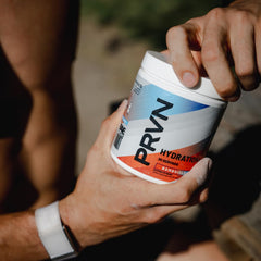 PRVN Performance Hydration mix in glass showing refreshing beverage after training.