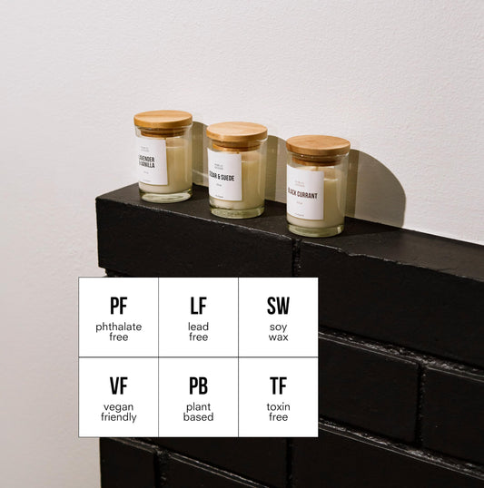 Public Goods Cedar & Suede candle jar with warm woodsy spice and leather notes.