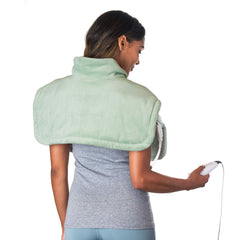 Pure Enrichment WeightedWarmth neck and shoulder wrap in use for comforting heat and gentle pressure.