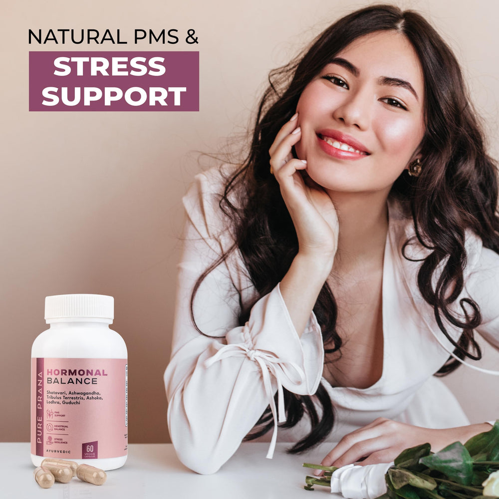 A woman holds a Pure Prana capsule as part of a daily wellness routine.