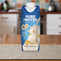 Pure Protein Vanilla Shake on the counter with a snack.