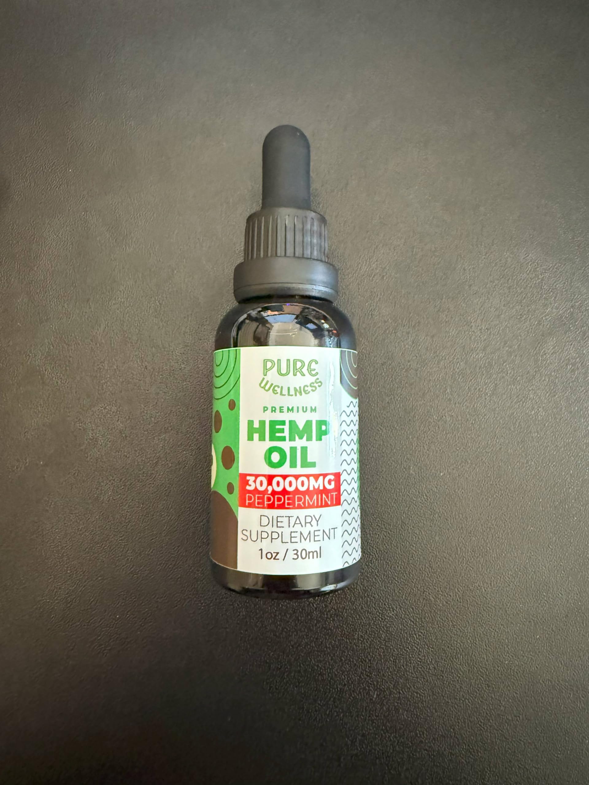 Cap on Pure Wellness peppermint hemp oil bottle in clean setting