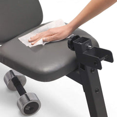 Purell hand wipes in use on a table, enabling portable surface sanitation.
