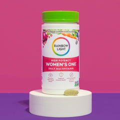 Rainbow Light Women's One powder on the kitchen counter ready to scoop.