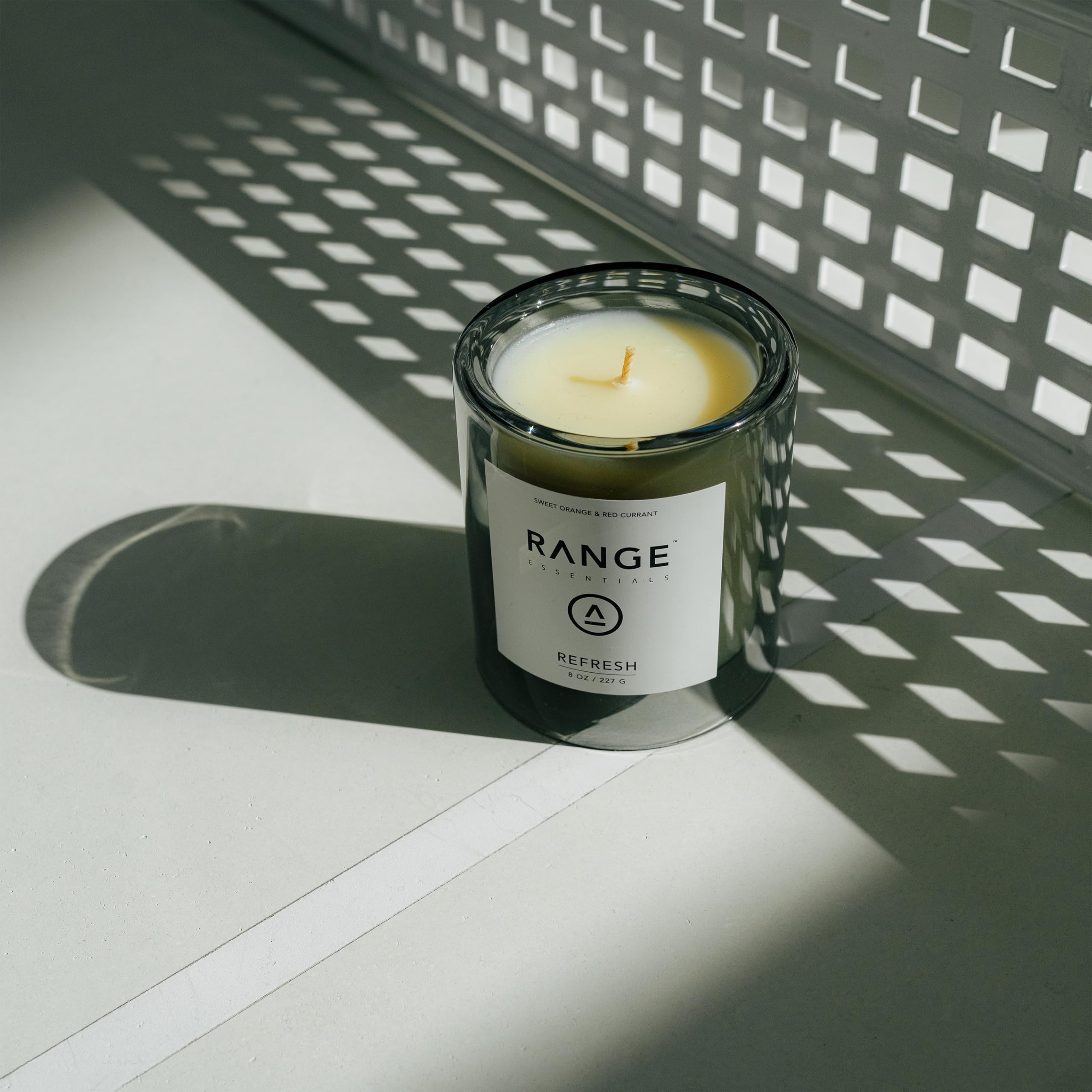 Range Essentials Refresh Candle glass jar image illustrates long-lasting aroma for living spaces.