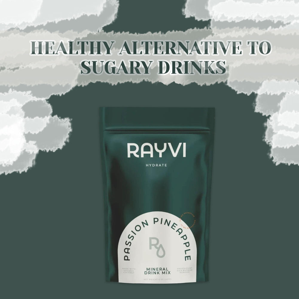 Rayvi glass with bright pineapple drink illustrates refreshing electrolyte hydration.