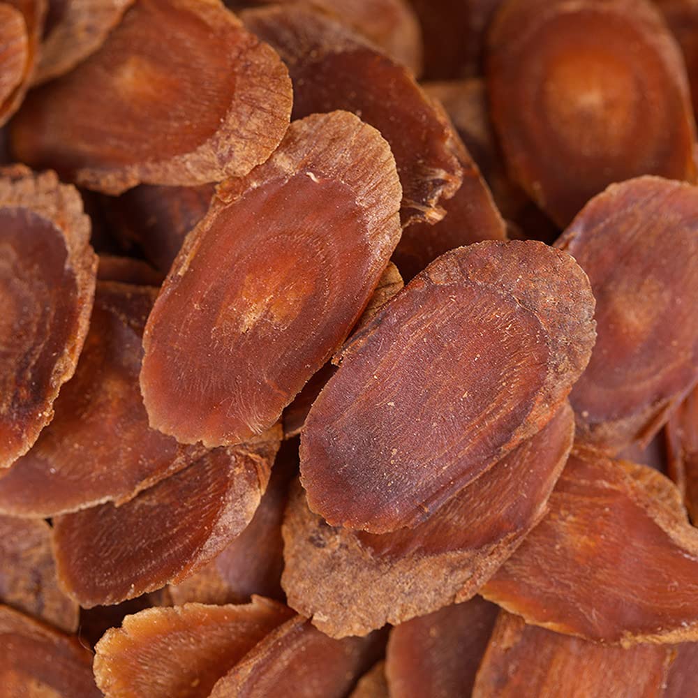 Korean red ginseng slices steeping in water, releasing rich aroma