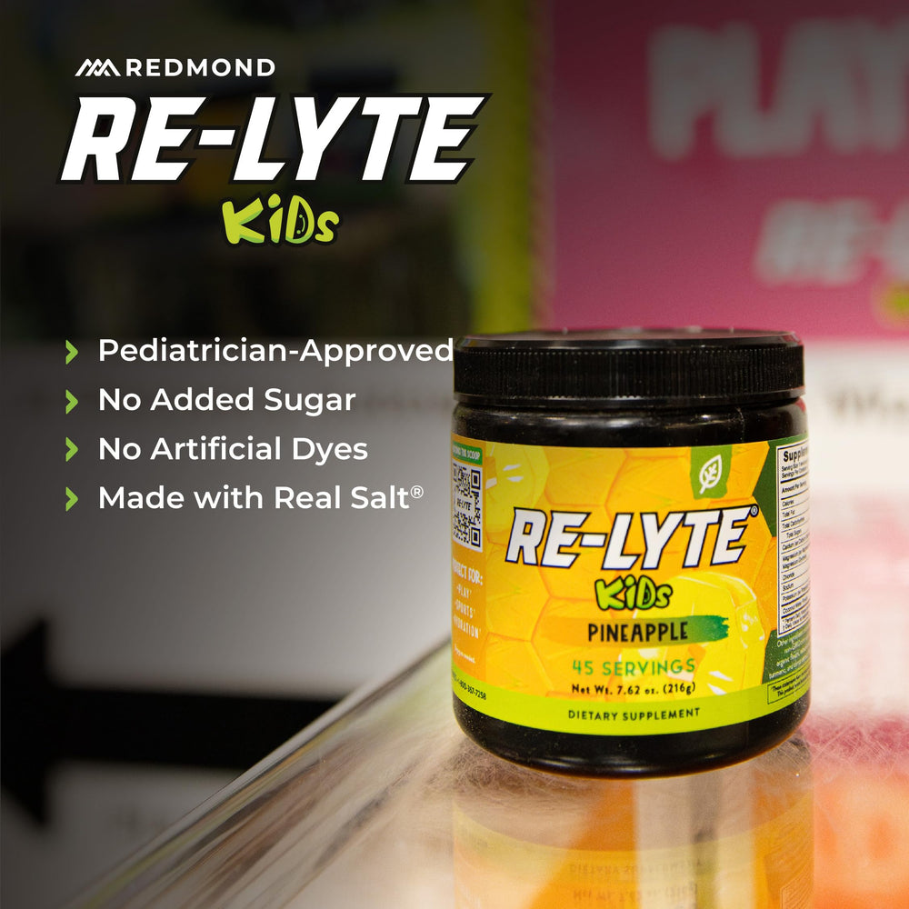 REDMOND Re-Lyte Kids Pineapple dissolving in water for on-the-go hydration.