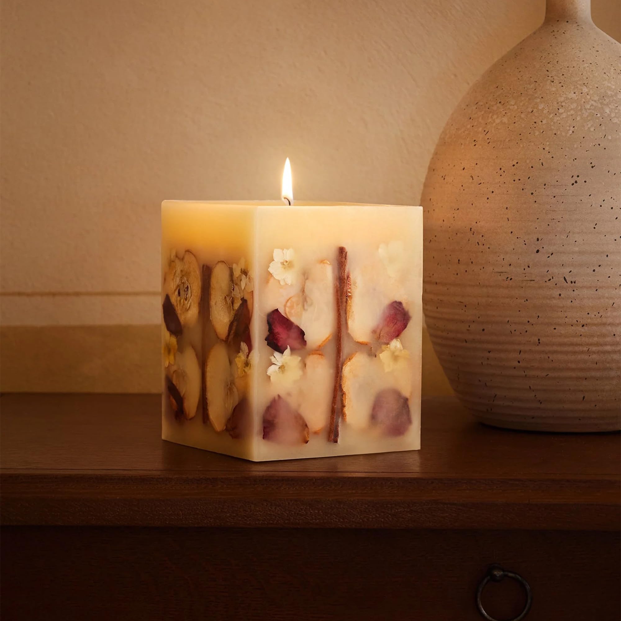Refillery Haus candle centerpiece enhances cozy living room decor.