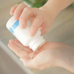 LunaRich X capsules being poured from bottle into a palm