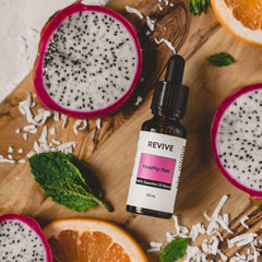 Massage-ready drop of REVIVEEO Healthy Hair Blend on scalp