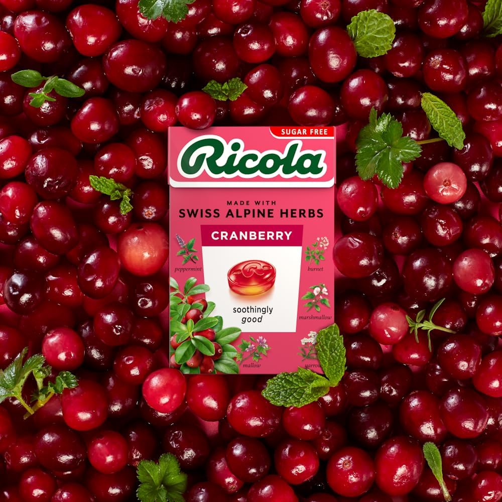Ricola Cranberry SF Lozenges closeup of lozenges showcasing real cranberry juice inclusion.