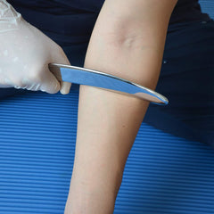Robulove IASTM set in use with handheld grip for targeted muscle treatment.