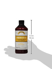 Rooster Booster B-12 Liquid bottle pour for precise supplementation.