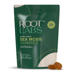 ROOT LABS Sea Moss Gummies bottle on table showcasing vegan, no added sugar formula.