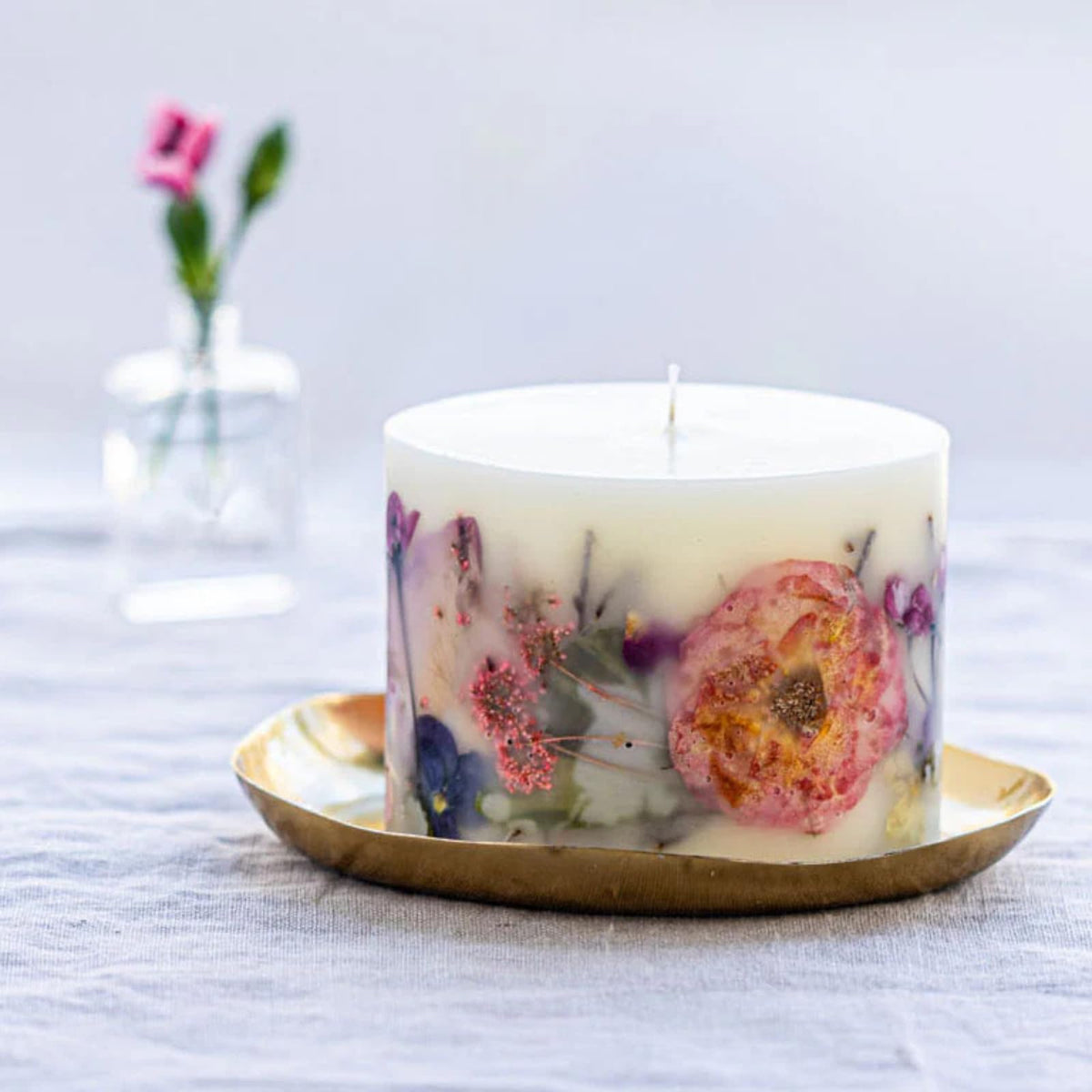 Rosy Rings Blushing Rosewood candle closeup showing delicate botanical accents for elegant decor.