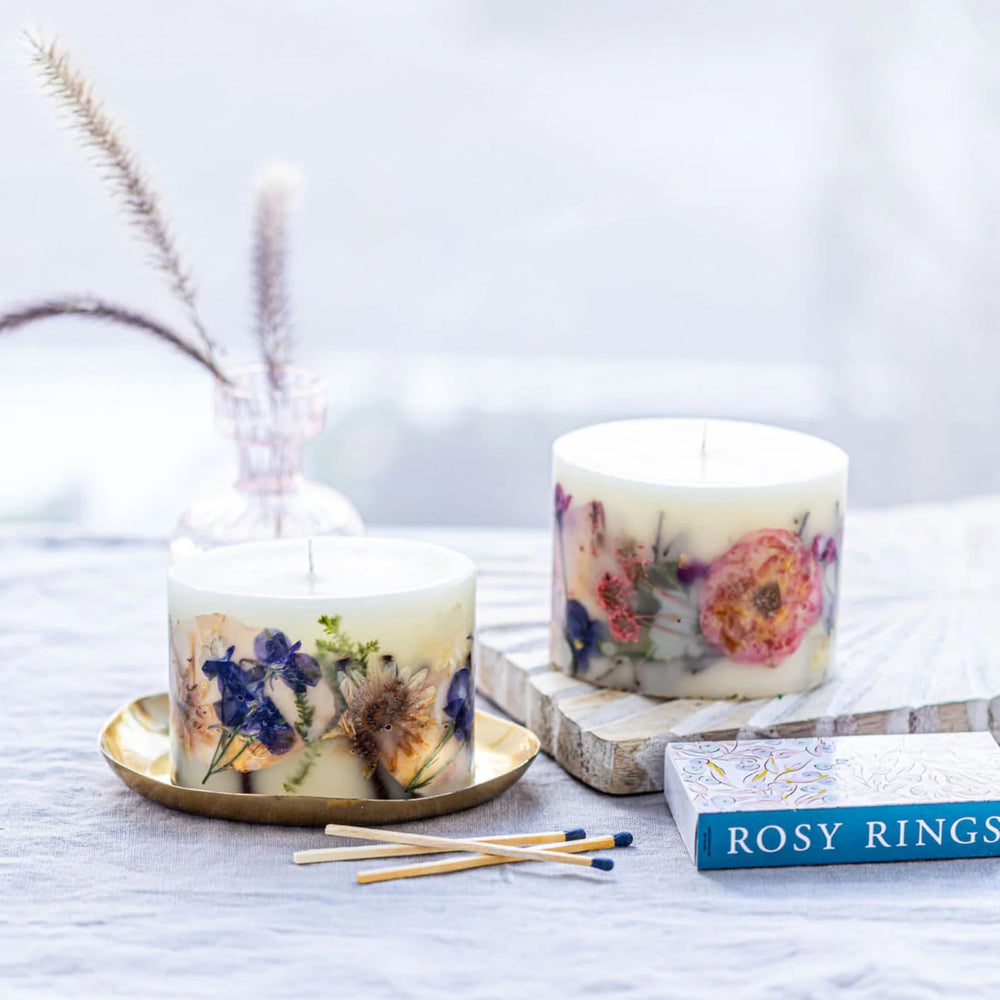 Rosy Rings Blushing Rosewood candle illuminated glow bathes space in warm luxury.