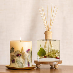Rosy Rings Frosted Fir candle on a mantel adds subtle luxury