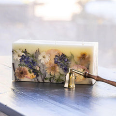 Rosy Rings Vanilla Rain brick candle with botanicals for luxurious home fragrance and ambiance.