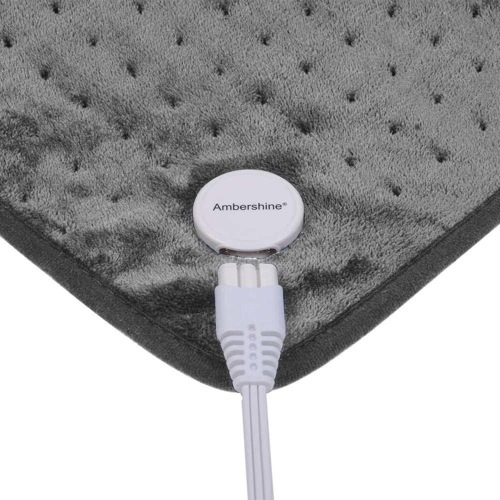 User applying pad to back and shoulders for targeted warmth