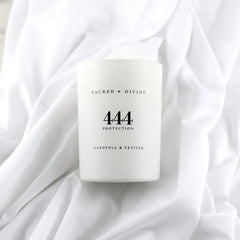 Minimalist white jar with Sacred + Divine 444 logo signaling pure intentions.