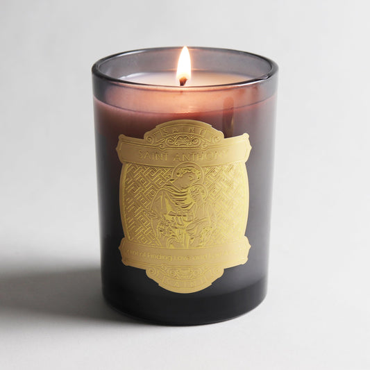 Saint Anthony padua candle featuring bergamot and oud aroma for calming ambiance.