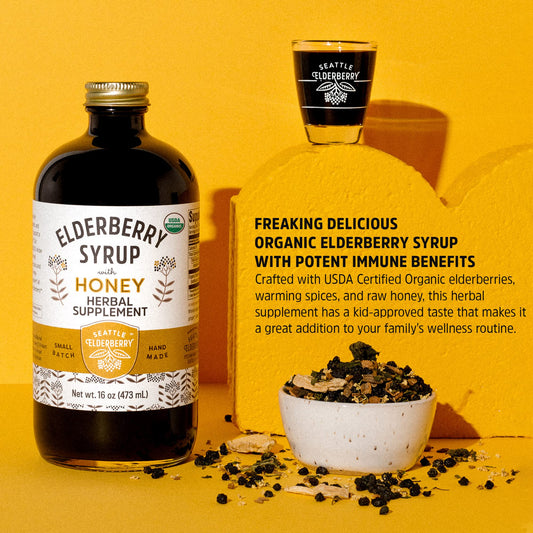 Spoonful of Seattle Elderberry Syrup ready for a family wellness moment.
