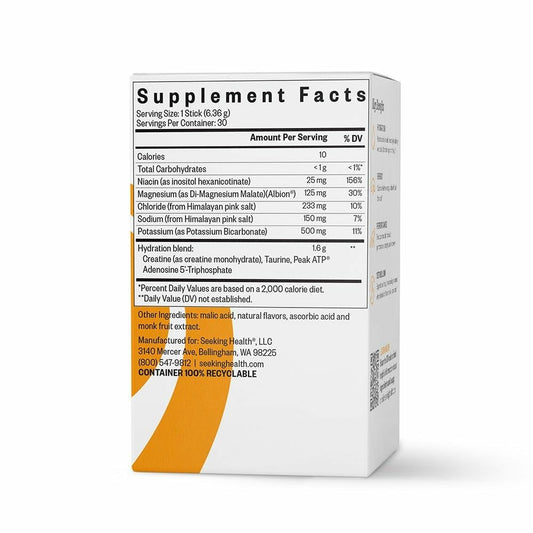 Glass of orange-flavored Seeking Health Electrolyte Sticks drink highlighting refreshing hydration.