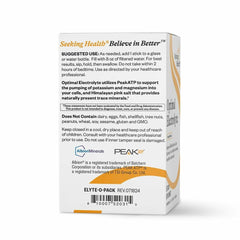Close-up of orange label on Seeking Health Electrolyte Sticks packaging showing vegan and non-GMO claims.