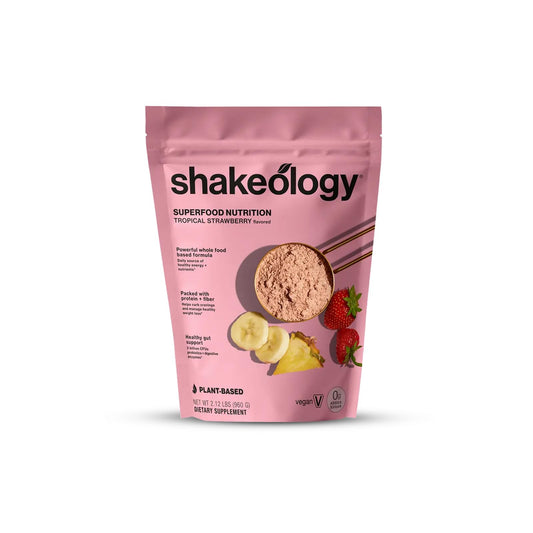 Shakeology tropical strawberry bottle highlighting gluten-free 0g added sugar