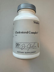 Shaklee Cholesterol Complex bottle on table highlights plant-based wellness support