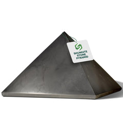 Shungite World authentic shungite pyramid 150mm on desk for protection and focus.