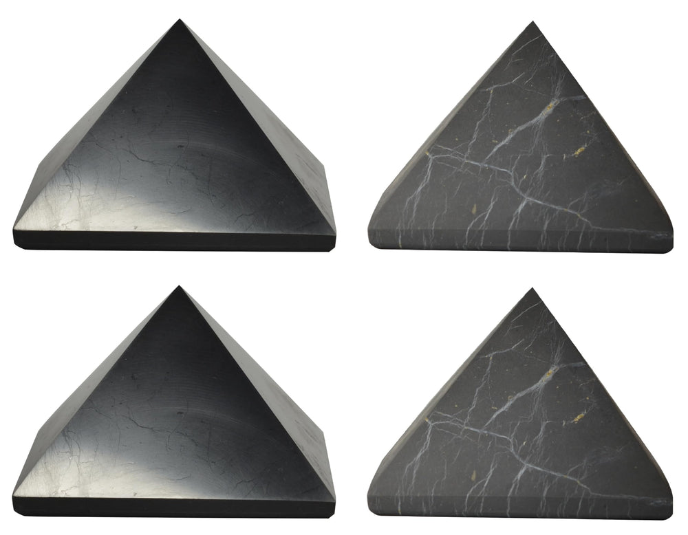 Shungite World polished pyramids 70mm on desk for focused energy protection.