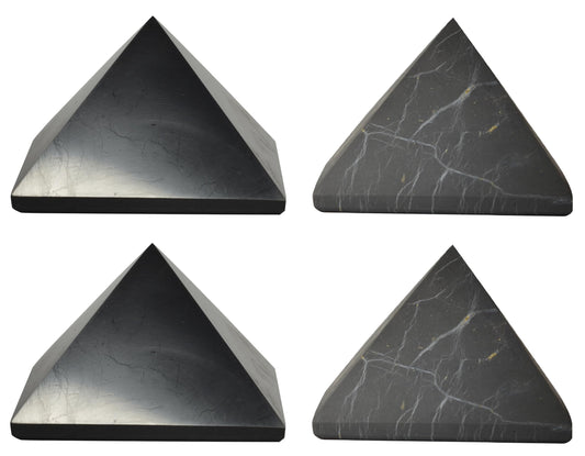 Shungite World polished pyramids 70mm on desk for focused energy protection.