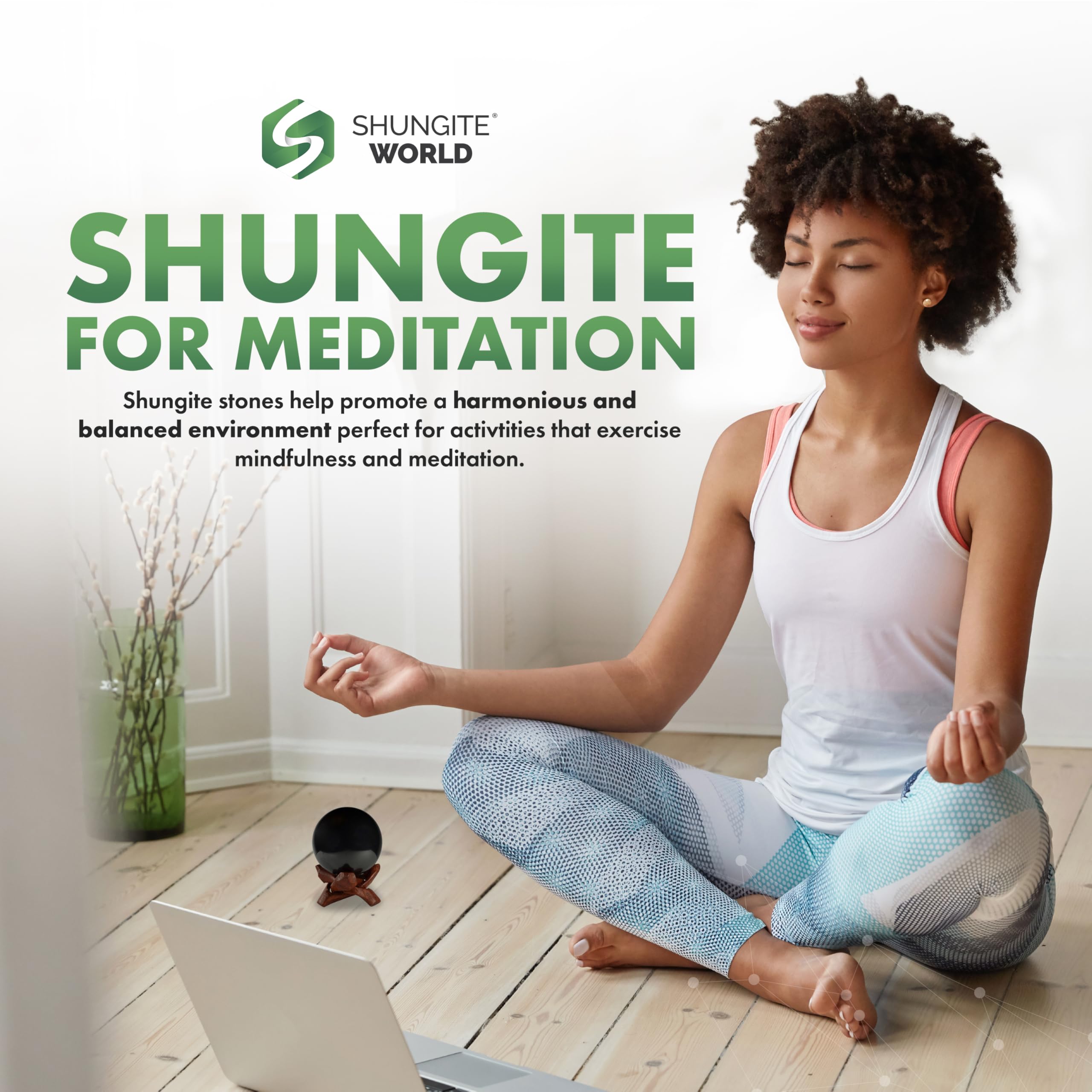 Shungite World sphere beside a laptop hinting at device-friendly grounding