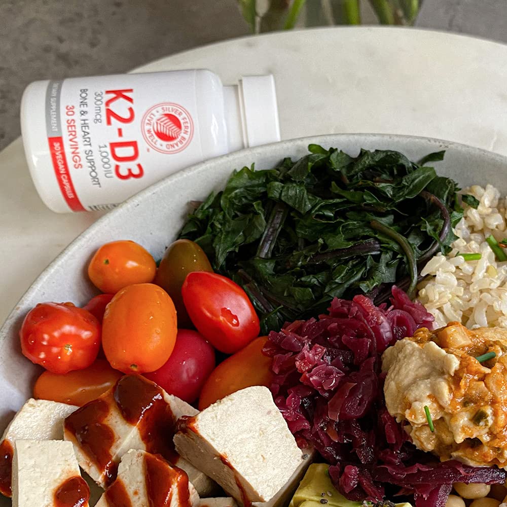 Pouring Silver Fern K2-D3 bottle to reveal easy daily capsules