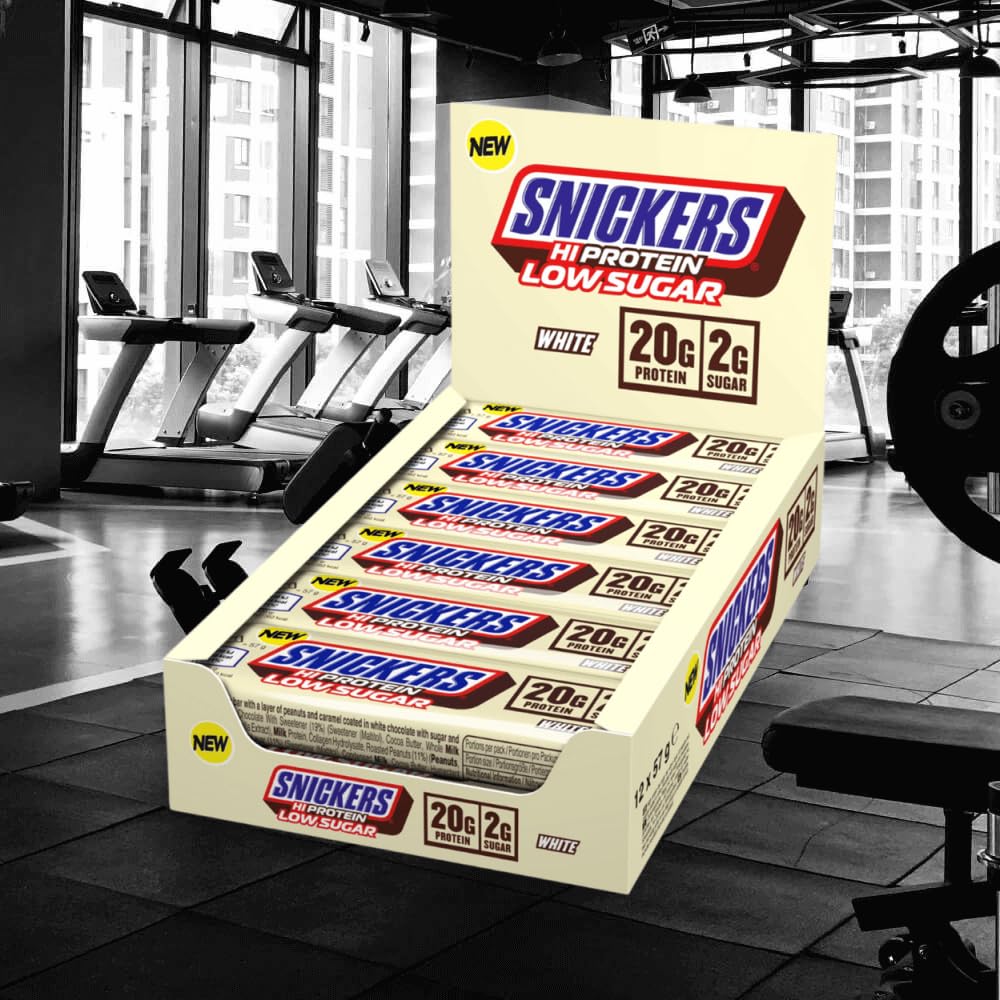 Snickers white chocolate bar closeup shows creamy coating and protein-rich bite