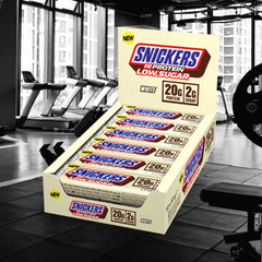 Snickers white chocolate bar closeup shows creamy coating and protein-rich bite