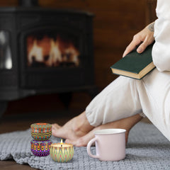 Candle burning with clean, smokeless flame inside a metal tin