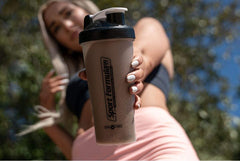 Sport Formula 99 post-workout shake in a glass with protein powder.