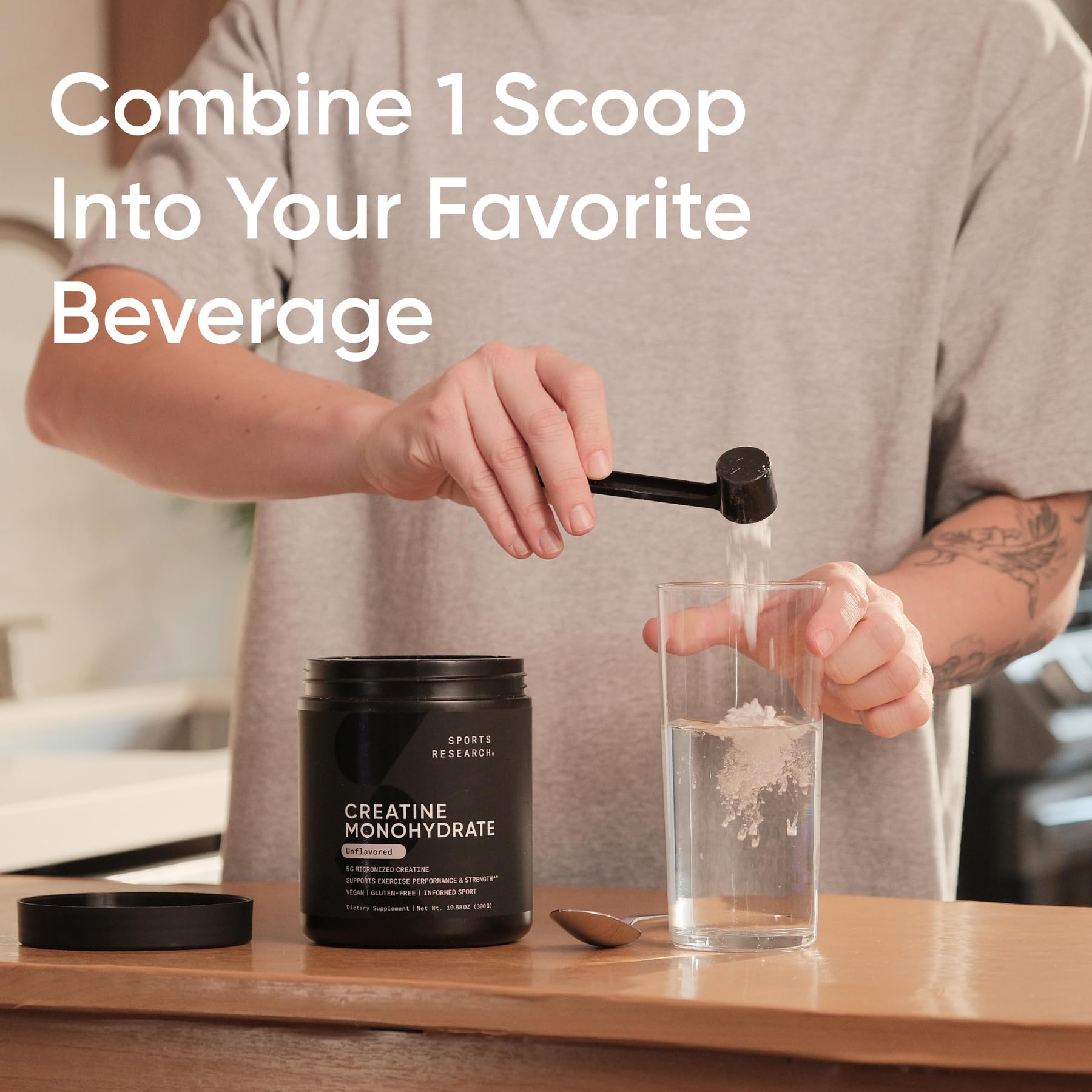 Sports Research Creatine powder dispensing close-up highlighting fine texture for smooth blending.
