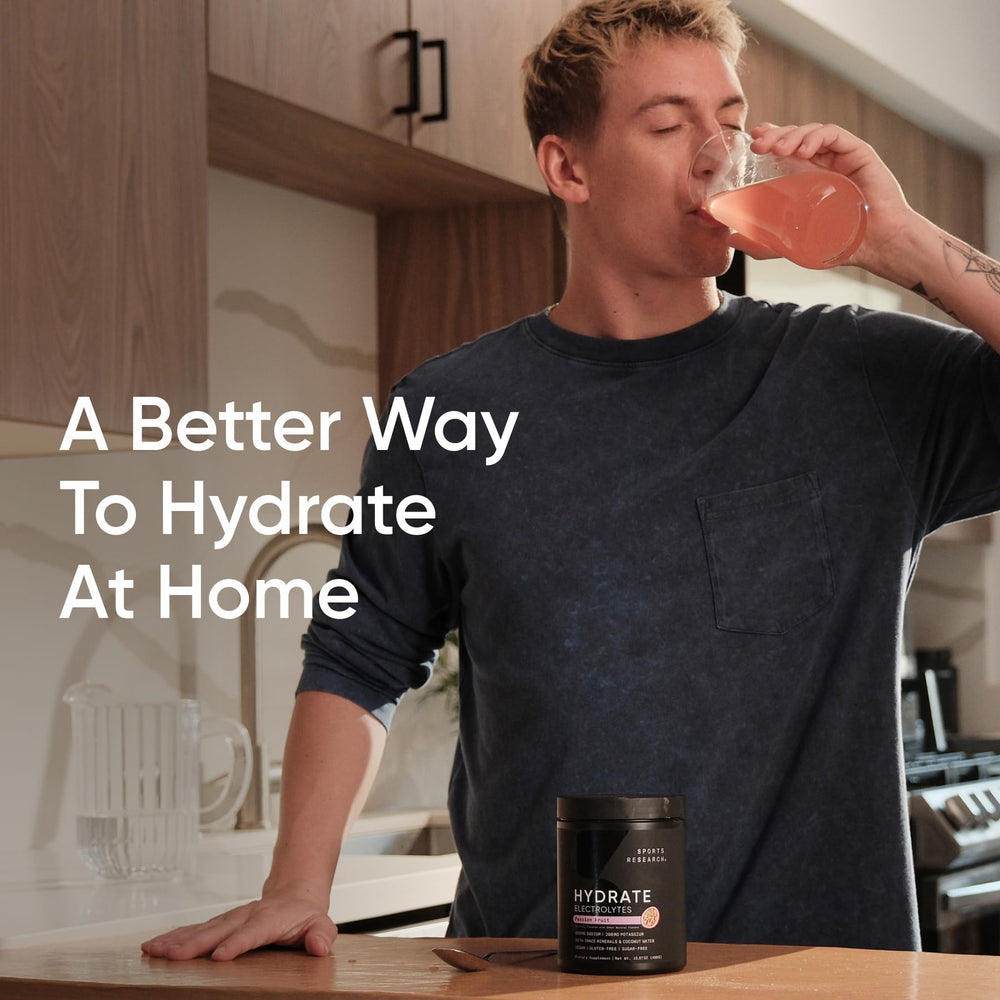 Sports Research Hydrate Passion Fruit flavor beside a glass
