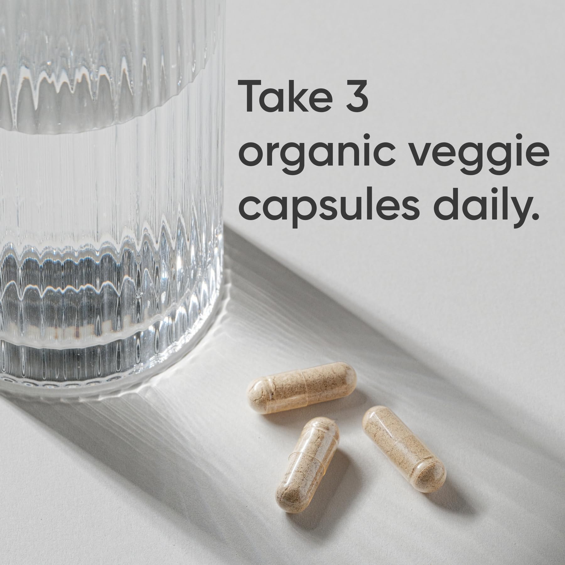 Sports Research Organic Lion's Mane capsules close-up highlighting vegan, non-GMO formula.