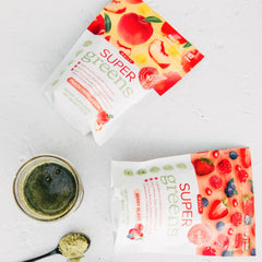 Sprigs Peach Flavor Super Greens powder bottle for convenient daily energy and immune support