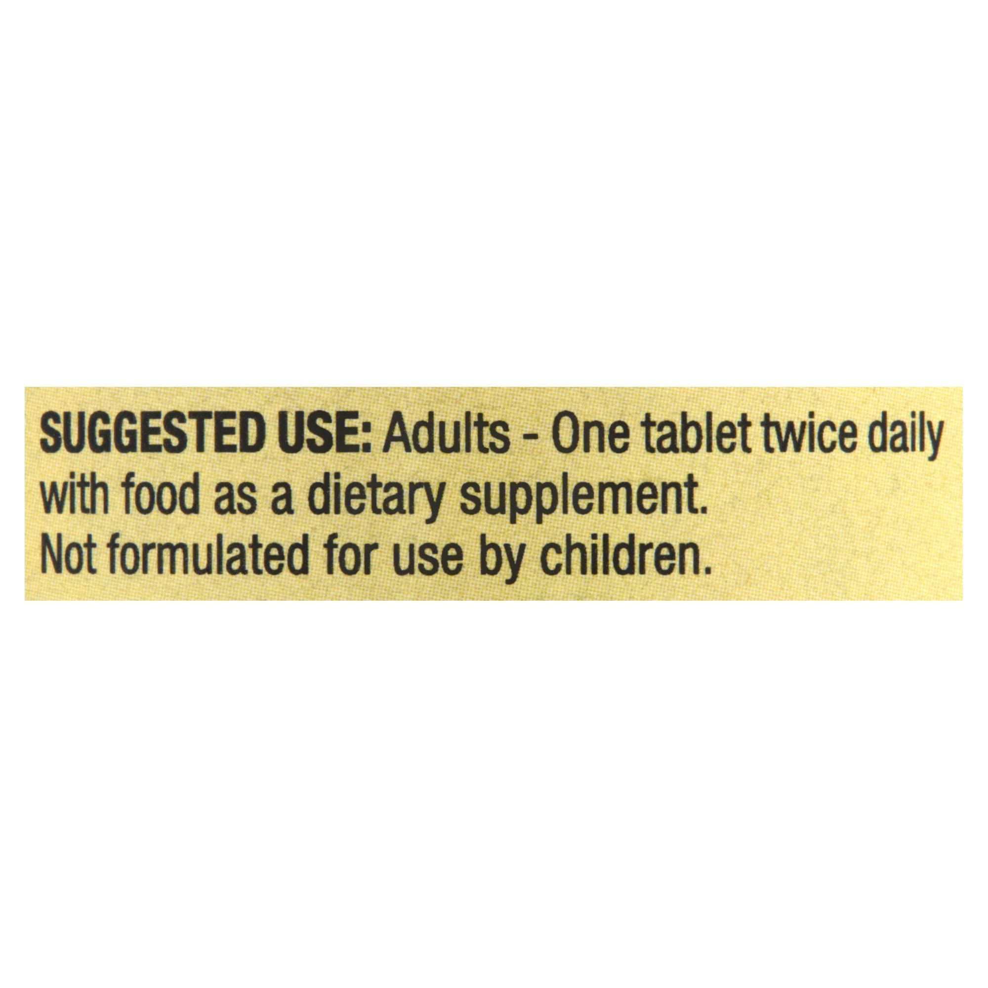 Spring Valley Calcium 600mg bottle with glass of water for easy intake.