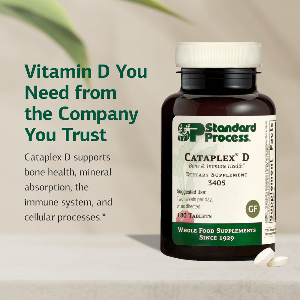 Standard Process Cataplex D tablets on white surface illustrate easy daily intake.