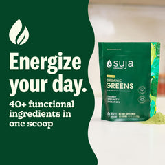 Suja Organic Greens powder scoop in cup ready to mix for nutrition.
