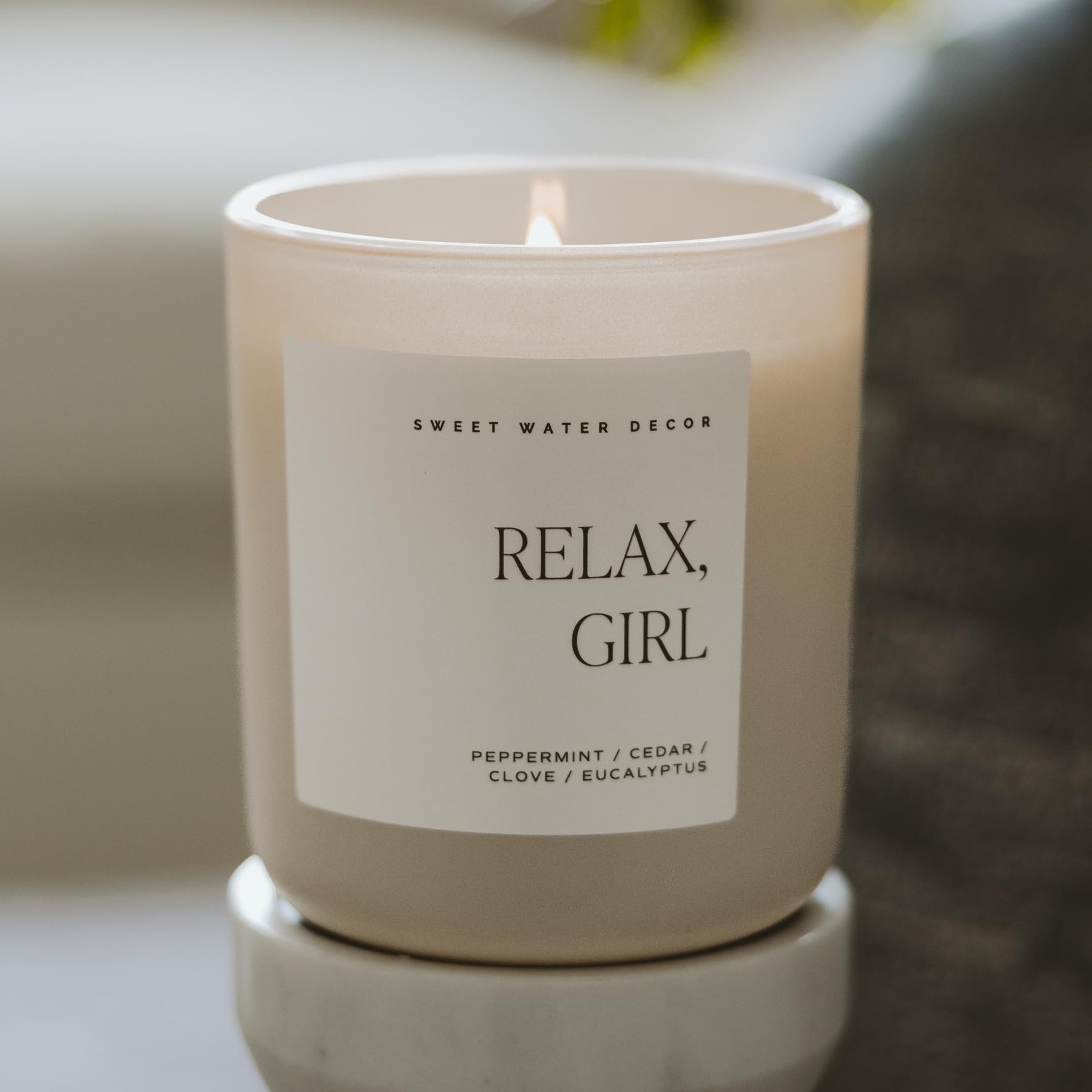 Sweet Water Decor Relax, Girl candle label shot communicates 15oz size and long burn time.