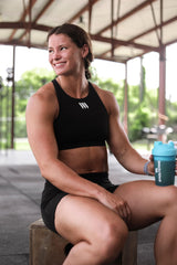 Coconut water poured beside Swolverine Intra Tropical Blast suggests natural hydration aid.