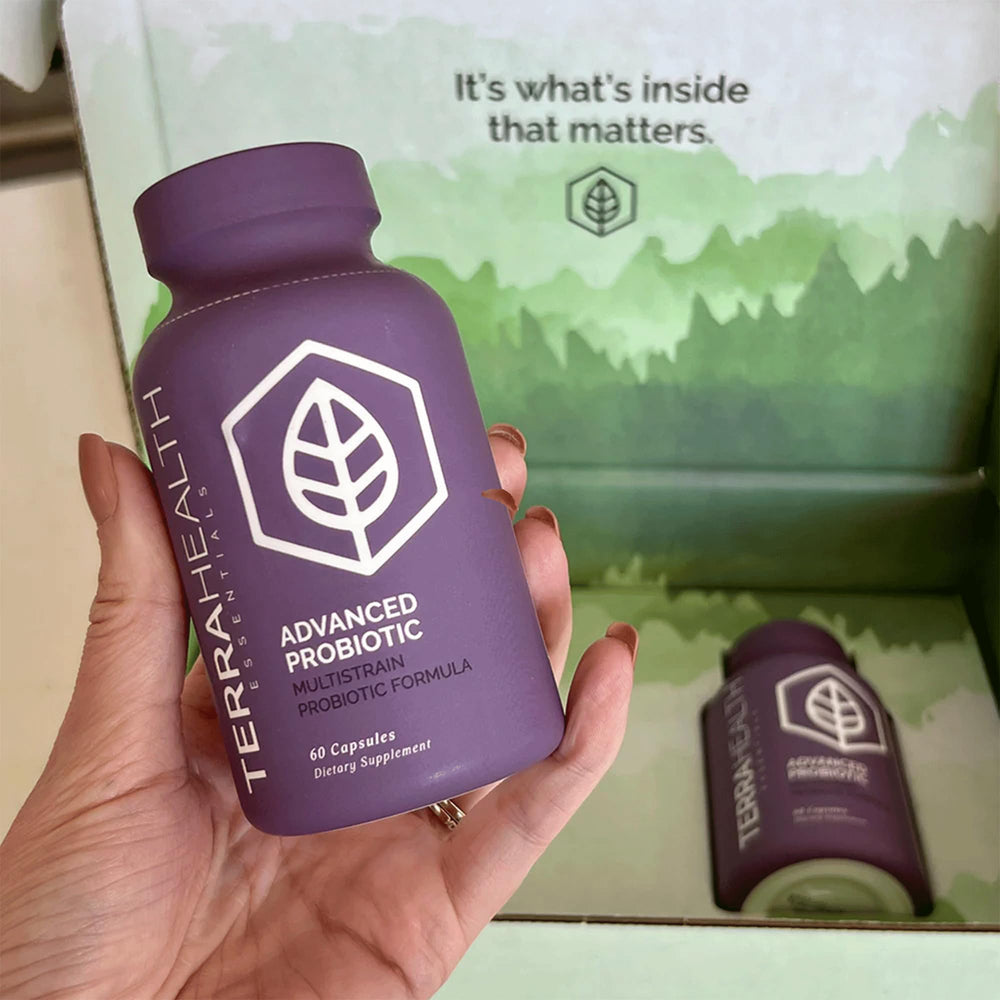 Terra Health Essentials Advanced Probiotics bottle with glass of water conveys easy daily intake.